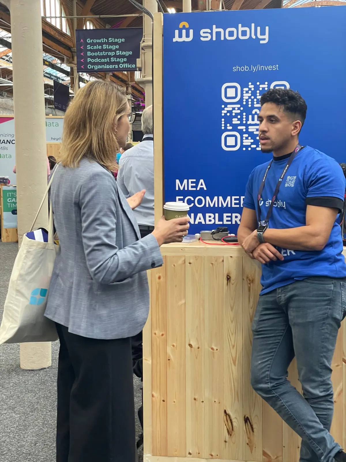 Talking with a visitor at the stand